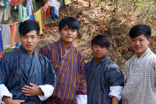 Young men wearing traditional Bhutanese clothing, as seen on the hike to The Tiger’s Nest.