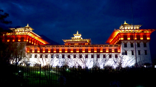 Parliament building illuminated at night.