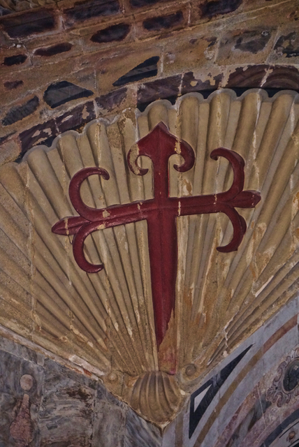 St. James cross, on the seashell symbol of Santiago, based on its proximity to the ocean