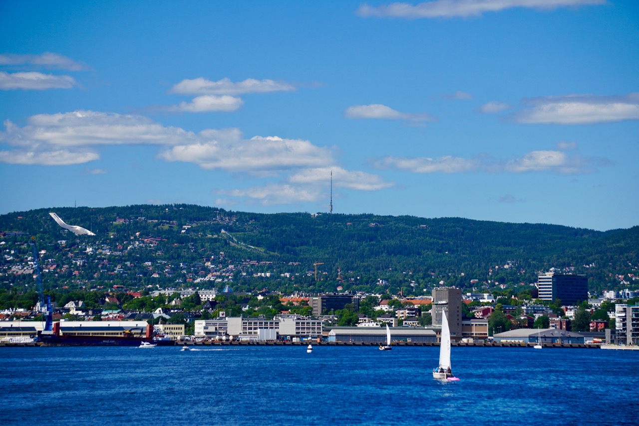 Downtown Oslo photographed from the ferry. The silver structure in the middle left is the Holmenkollen Ski Jump