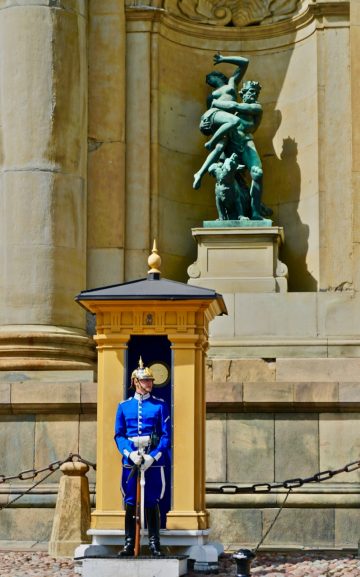 A royal palace guard defending a classic mythological rape scene