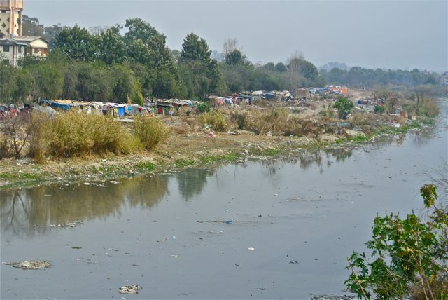 Squatters' shacks by the smelly river
