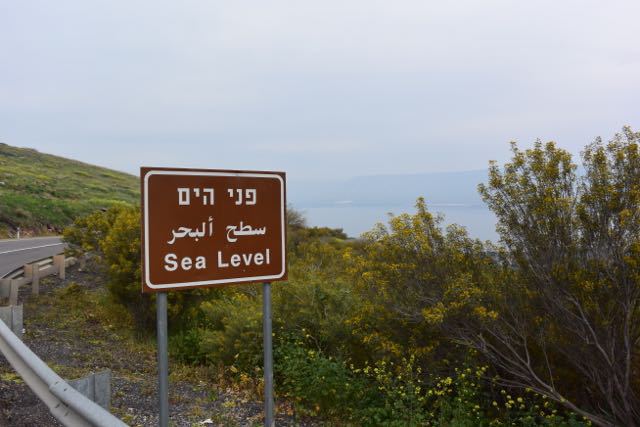 At sea level, looking down hundreds of feet below sea level to the Sea of Galilee