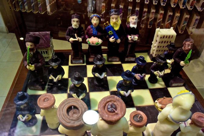 A chess set made of candles representing different Jewish figures